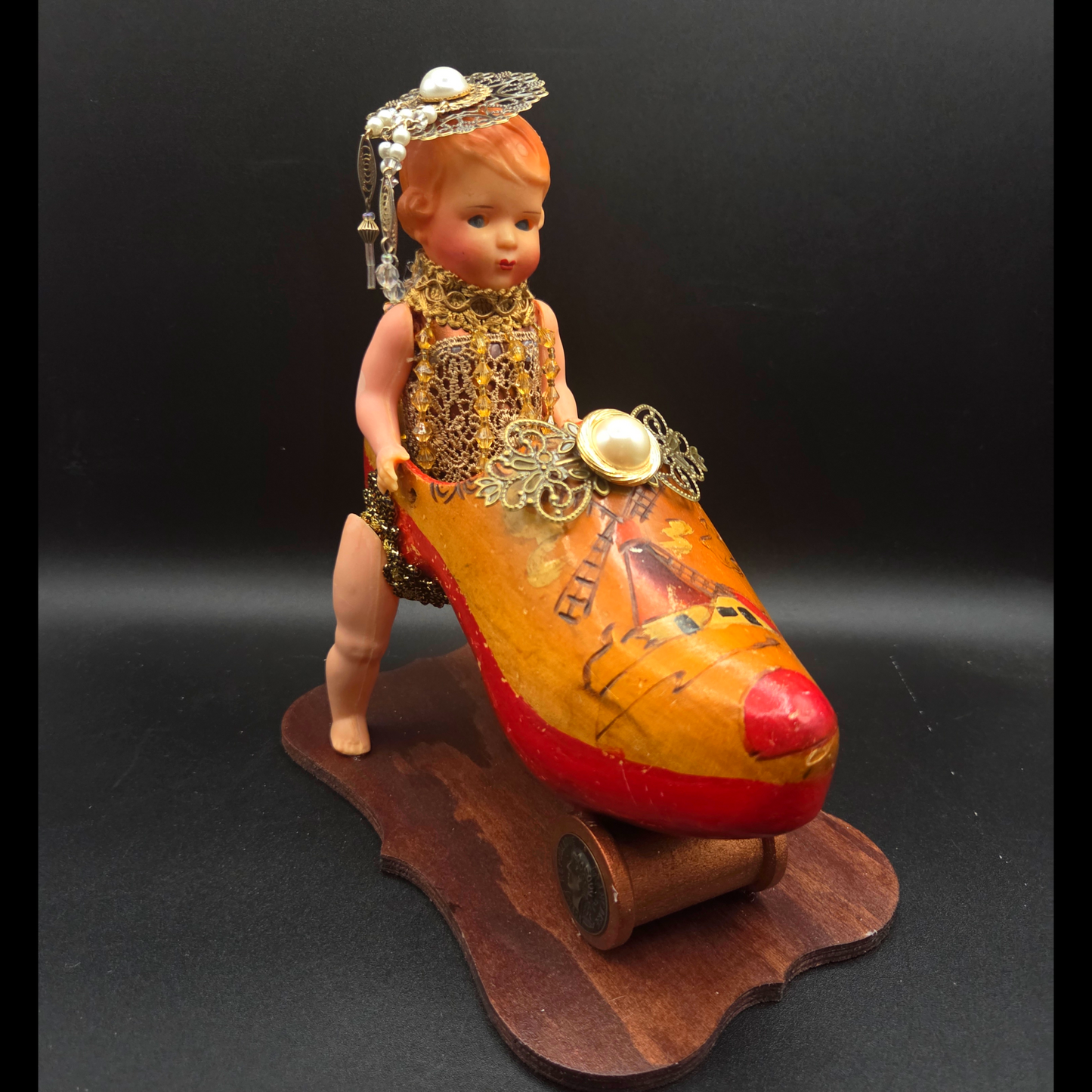 Kitschy Doll in an Antique Wooden Shoe Car