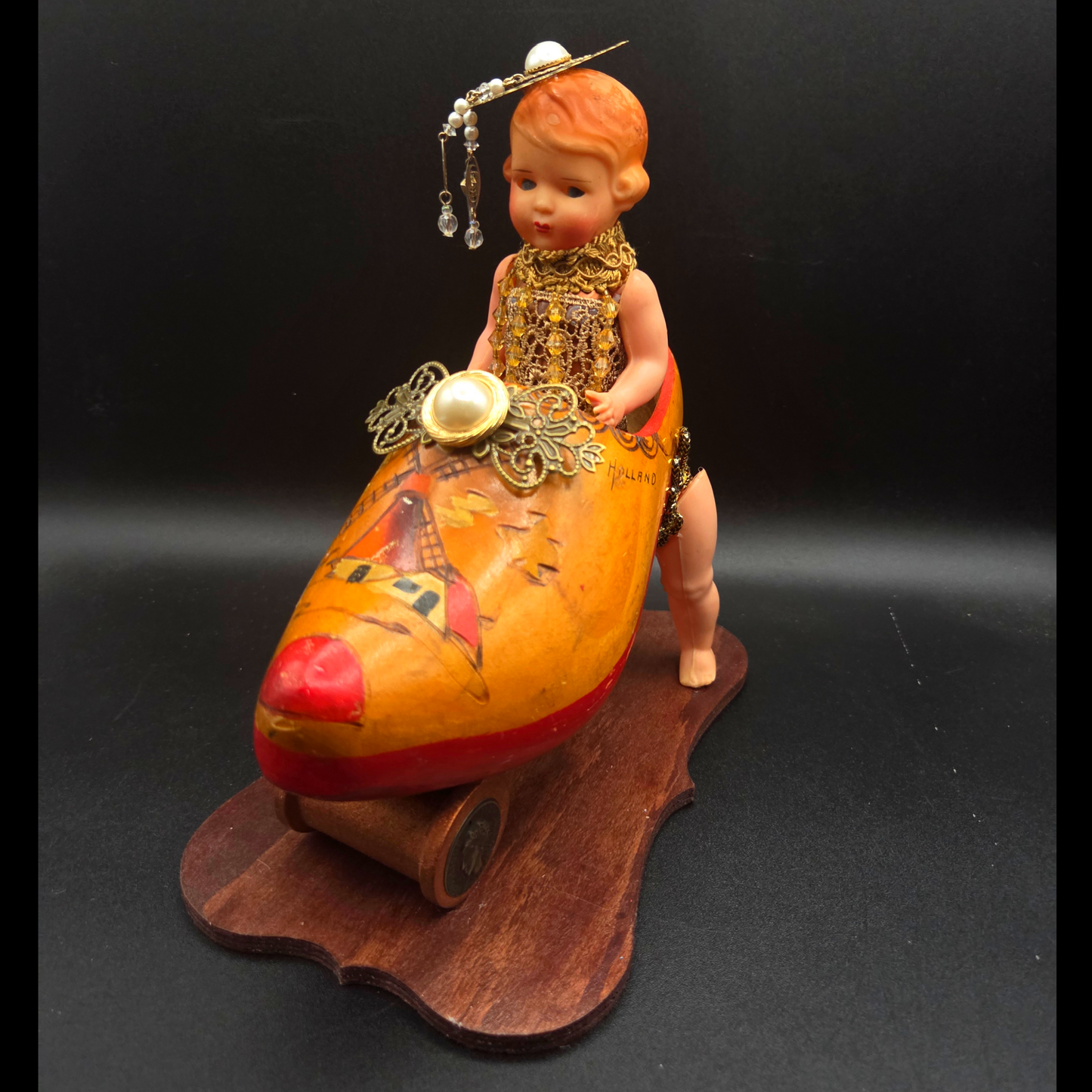 Kitschy Doll in an Antique Wooden Shoe Car